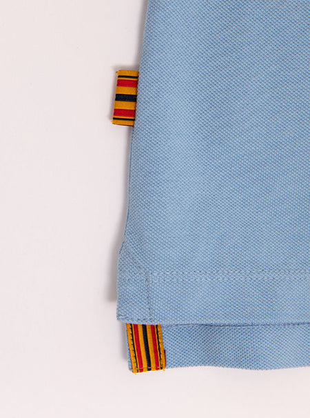 Close up flat lay of mens 100% cotton polo in a sky blue colour with the Newmarket 875 brand tag.